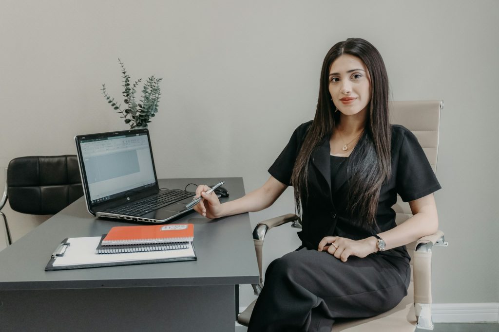 Professional woman working at a laptop desk