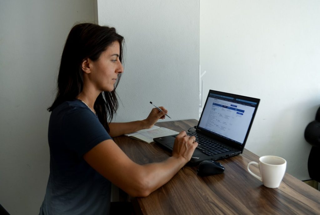 Woman sitting at a table with a laptop