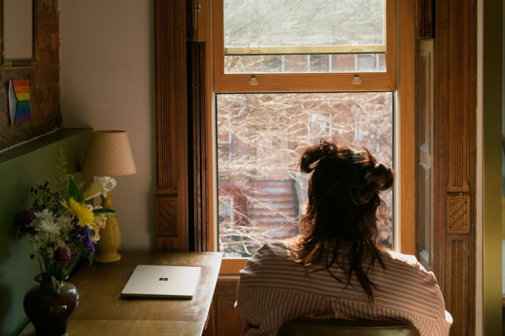 Woman sitting in a chair looking out a window