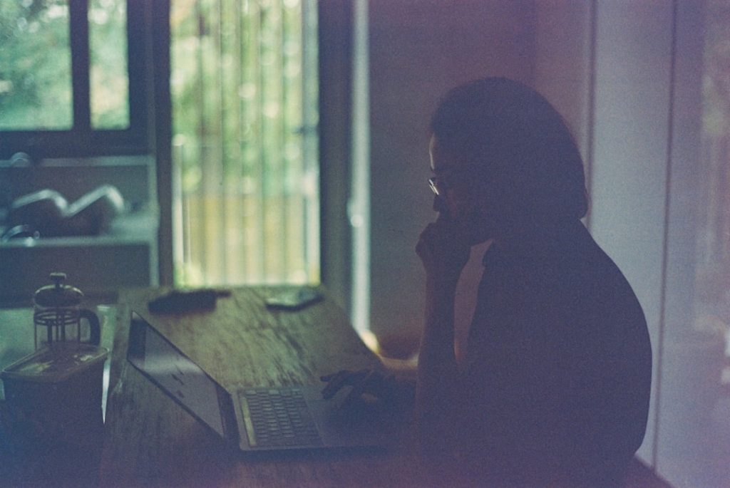 Professional making a calm career exit plan with a laptop and notebook