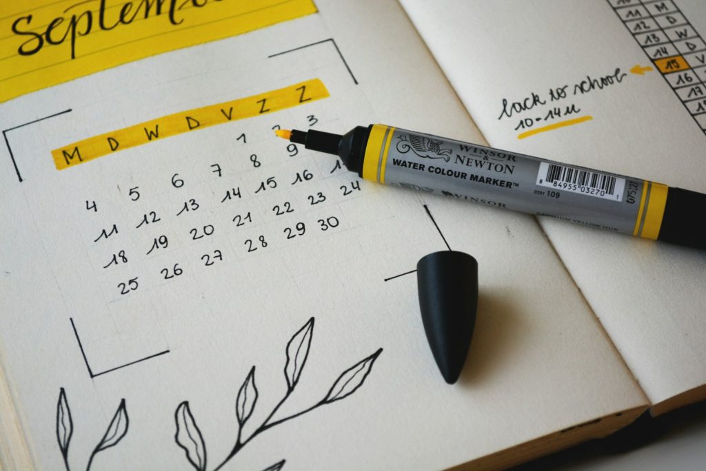 Calm weekly planner with a pen and coffee on a desk